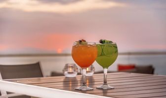 Outdoor terrace and drinks at Grand Miramar All Luxury Suites & Residences.