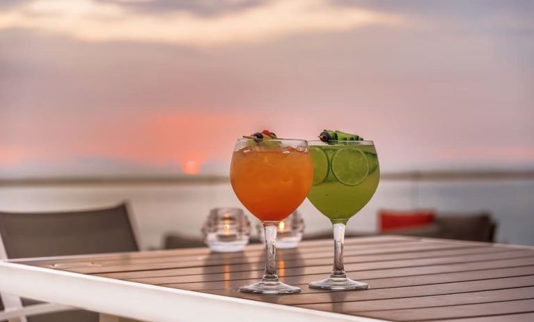 Outdoor terrace and drinks at Grand Miramar All Luxury Suites & Residences.