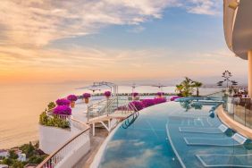 Outdoor pool with pool chairs at Grand Miramar All Luxury Suites & Residences.