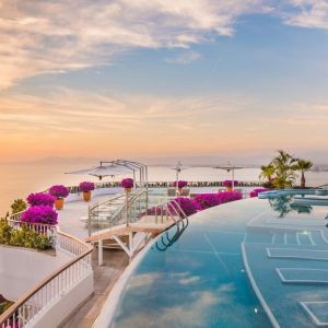 Outdoor pool with pool chairs at Grand Miramar All Luxury Suites & Residences.