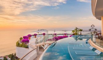 Outdoor pool with pool chairs at Grand Miramar All Luxury Suites & Residences.