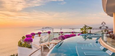 Outdoor pool with pool chairs at Grand Miramar All Luxury Suites & Residences.