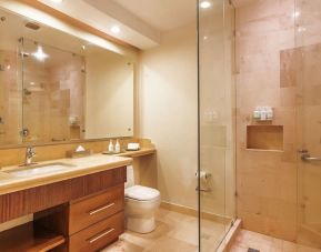 Guest bathroom with shower at Grand Miramar All Luxury Suites & Residences.