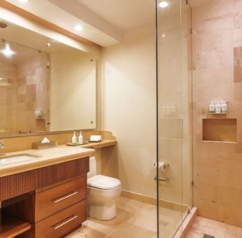 Guest bathroom with shower at Grand Miramar All Luxury Suites & Residences.