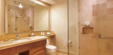 Guest bathroom with shower at Grand Miramar All Luxury Suites & Residences.