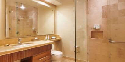 Guest bathroom with shower at Grand Miramar All Luxury Suites & Residences.