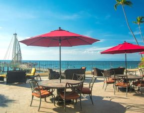 Outdoor terrace and seating area at Hotel Delfin PV Beach Resort.