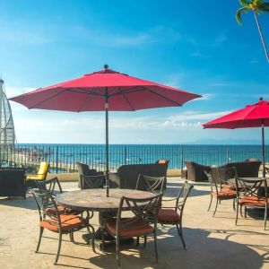 Outdoor terrace and seating area at Hotel Delfin PV Beach Resort.