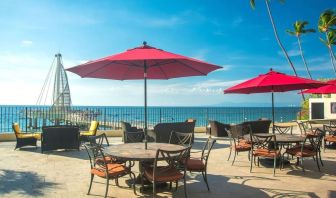 Outdoor terrace and seating area at Hotel Delfin PV Beach Resort.