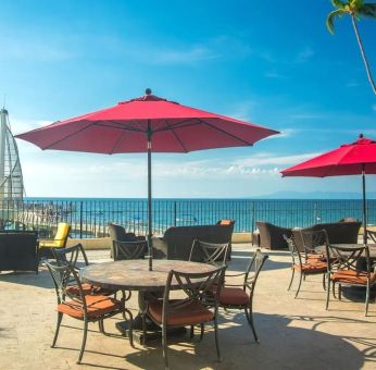 Outdoor terrace and seating area at Hotel Delfin PV Beach Resort.