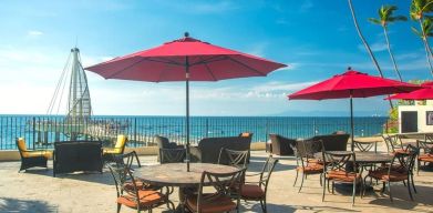 Outdoor terrace and seating area at Hotel Delfin PV Beach Resort.