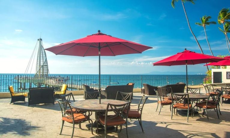 Outdoor terrace and seating area at Hotel Delfin PV Beach Resort.