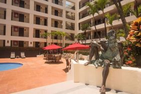 Outdoor pool and seating area at Hotel Delfin PV Beach Resort.