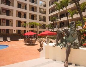 Outdoor pool and seating area at Hotel Delfin PV Beach Resort.