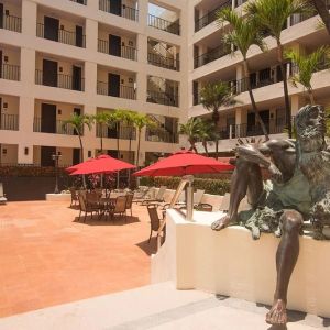 Outdoor pool and seating area at Hotel Delfin PV Beach Resort.