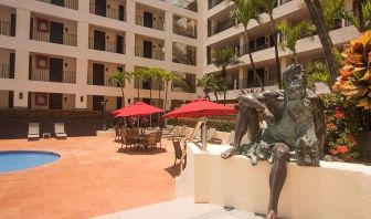 Outdoor pool and seating area at Hotel Delfin PV Beach Resort.