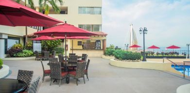 Outdoor seating and coworking space at Hotel Delfin PV Beach Resort.