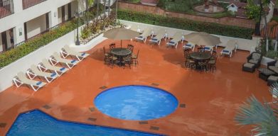 Bird's eye view of outdoor pool area at Hotel Delfin PV Beach Resort.