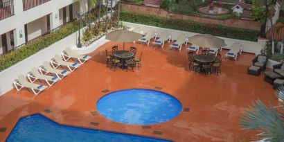 Bird's eye view of outdoor pool area at Hotel Delfin PV Beach Resort.