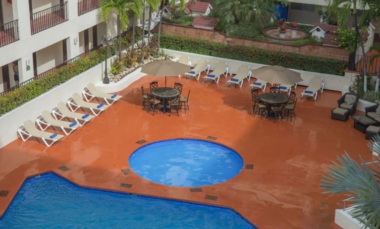 Bird's eye view of outdoor pool area at Hotel Delfin PV Beach Resort.