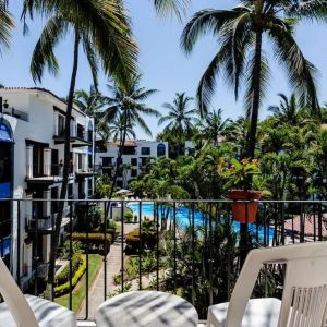 Balcony with pool view at Puerto De Luna Pet Friendly & Family Suites.