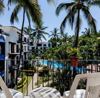 Balcony with pool view at Puerto De Luna Pet Friendly & Family Suites.