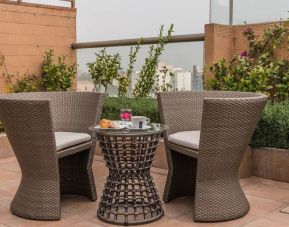 Terrace and seating area at Suites Perisur Furnished Apartments.