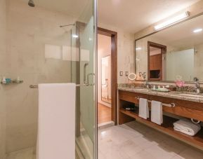 Guest bathroom with shower at Suites Perisur Furnished Apartments.