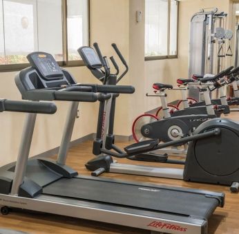 Fitness center at Suites Perisur Furnished Apartments.