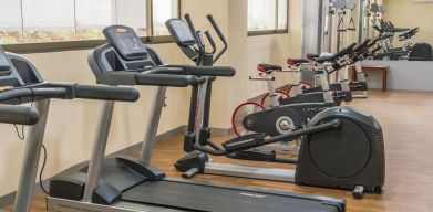 Fitness center at Suites Perisur Furnished Apartments.