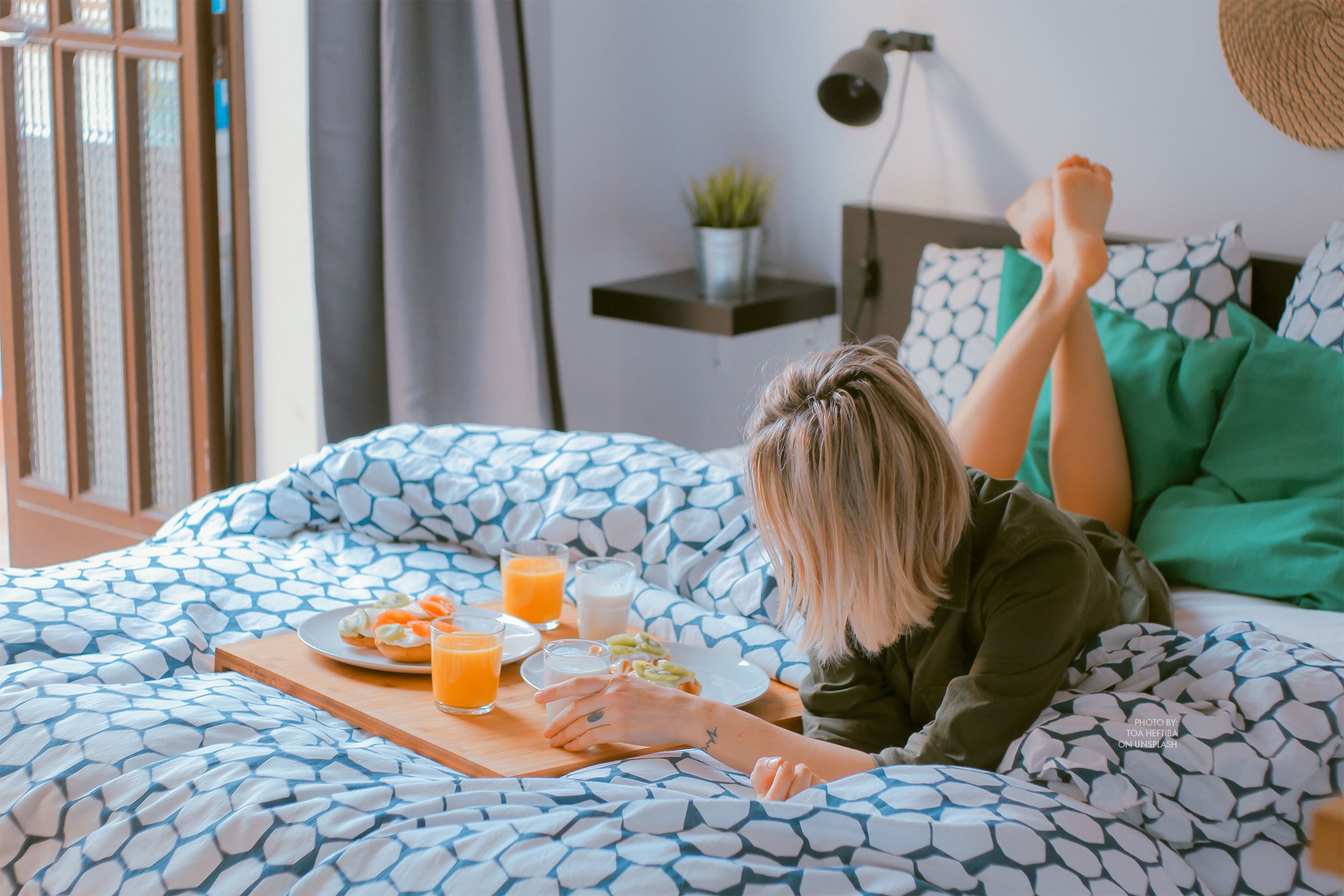 Hotel Daycations Offer Alternative Vacays in Post-Pandemic World - Lady lounging hotel bed