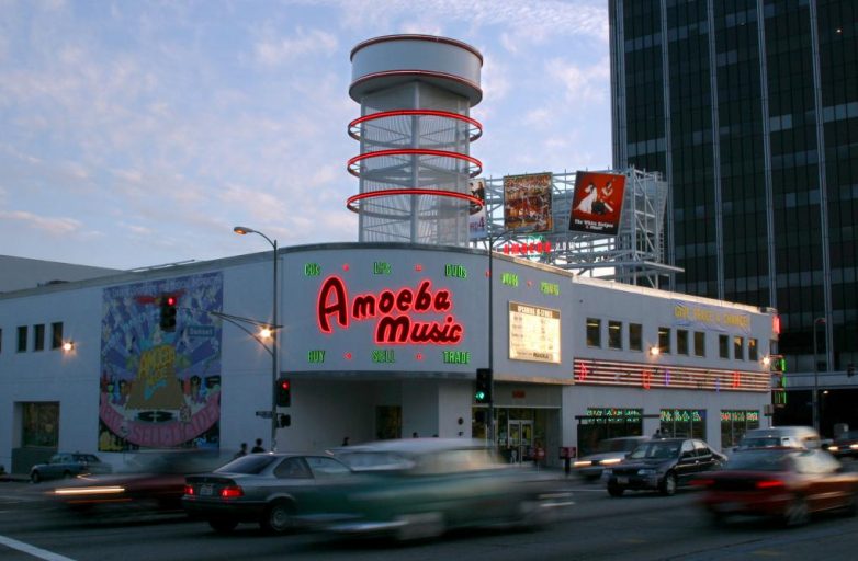 View of Amoeba Music exterior as cars whiz by on Sunset Boulevard in Hollywood, LA.