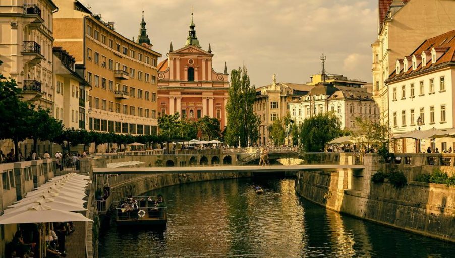 The Ljubljanica River winds through Ljubljana, Slovenia on a sunny afternoon.