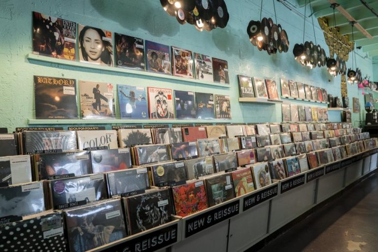 Aqua-colored walls, vinyl chandeliers and records fill the view inside Miami's Sweat Records.