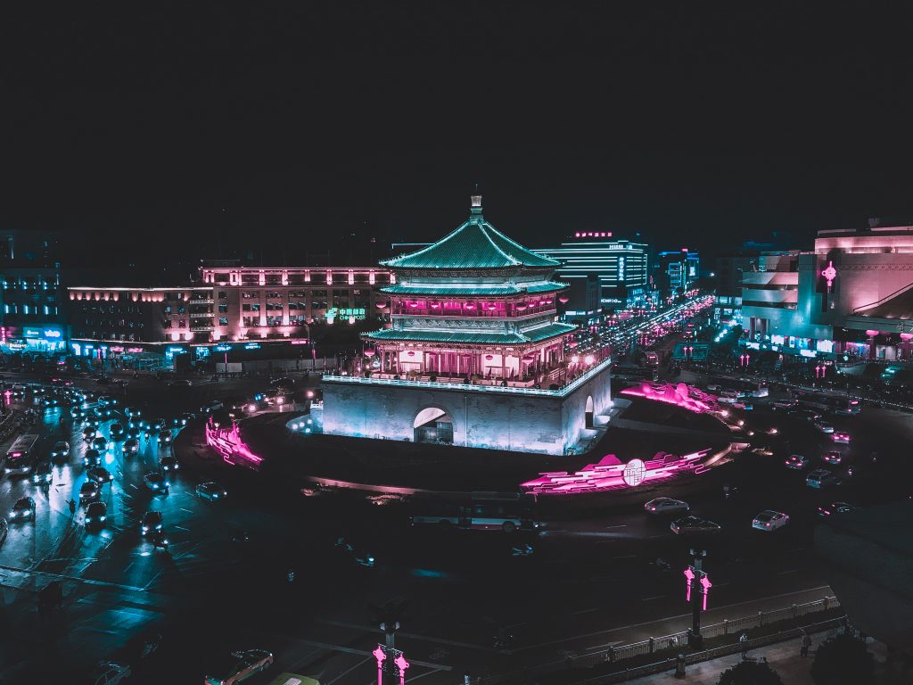 The Bell Tower of Xi'an and road circling it lit up at night in Xi'an, China.